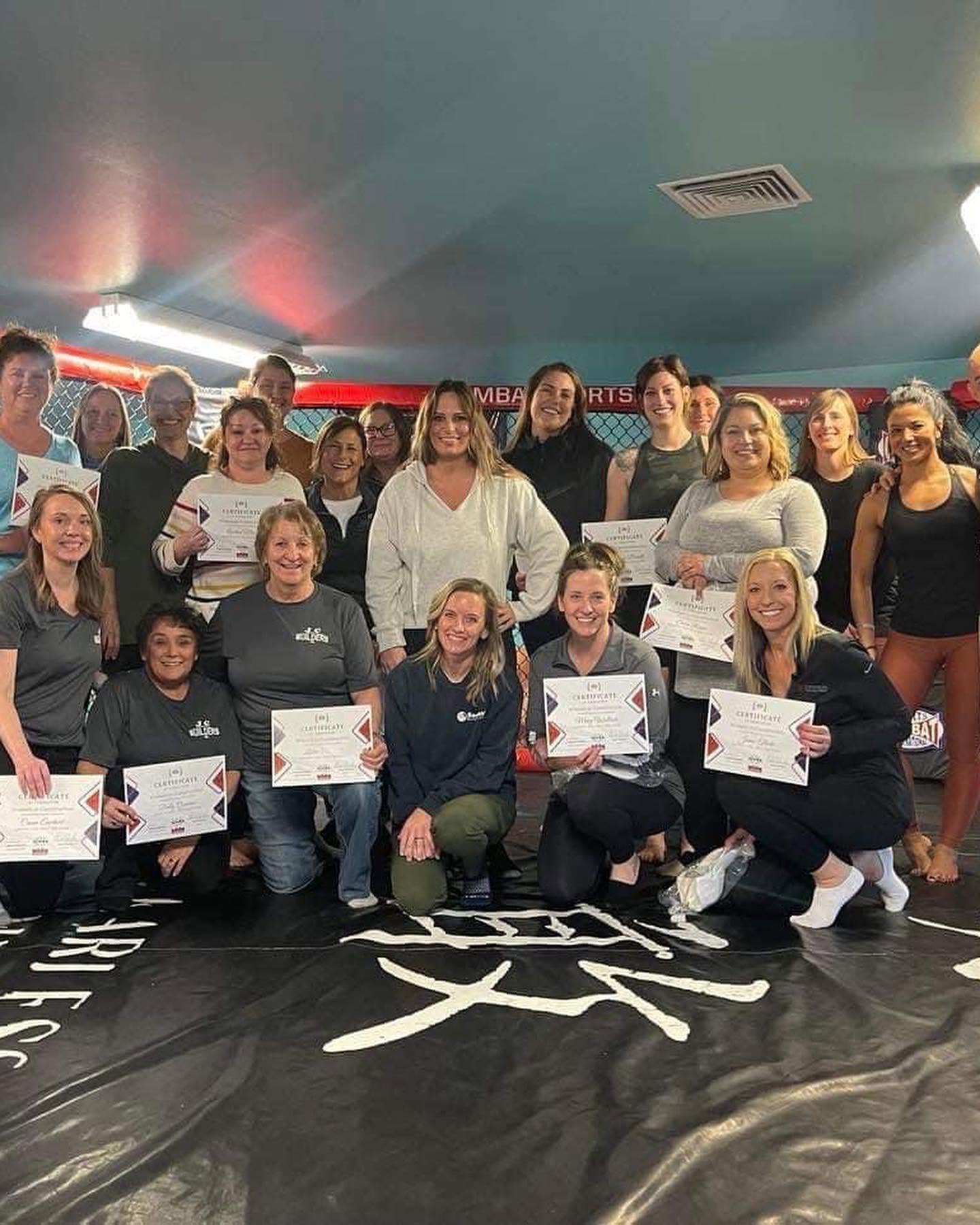 Self-defense seminar group photo with certificates